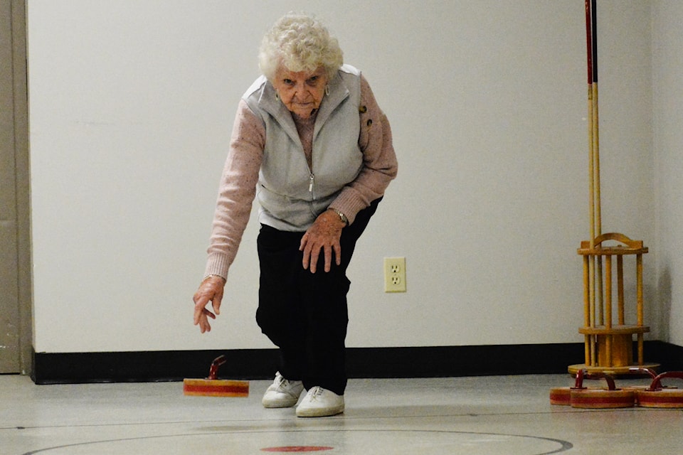 Madge Struthers plays floor curling Tuesday, Feb. 18, at the Williams Lake Seniors Activity Centre. 