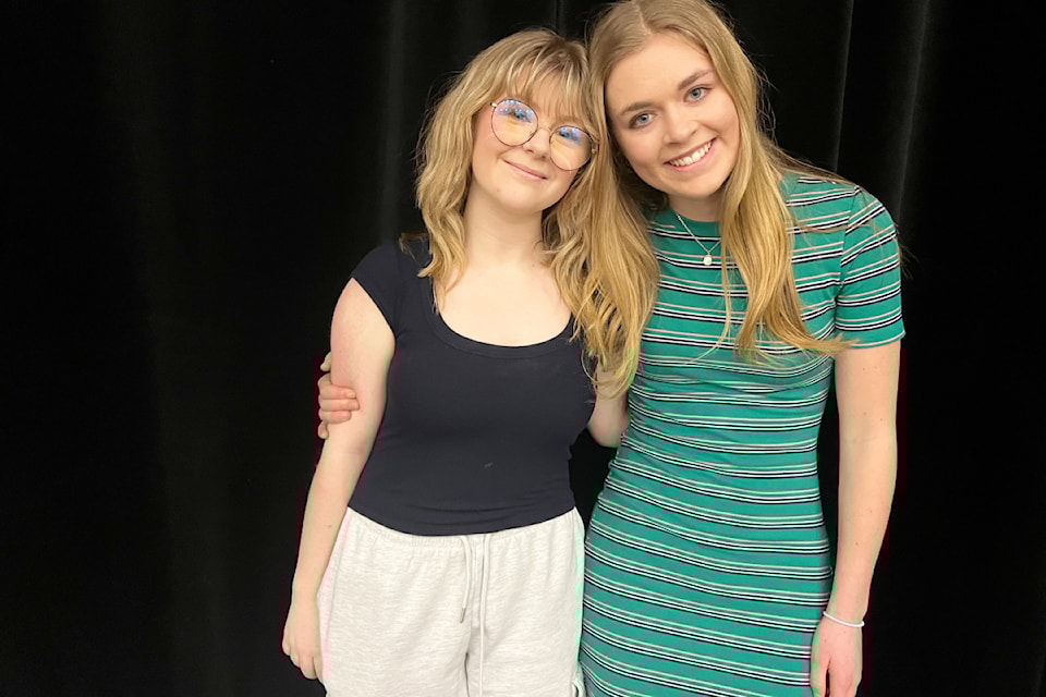 Addison Fairburn, left, and Ella Kruus are all smiles as they prepare for the Matilda dress rehearsal.