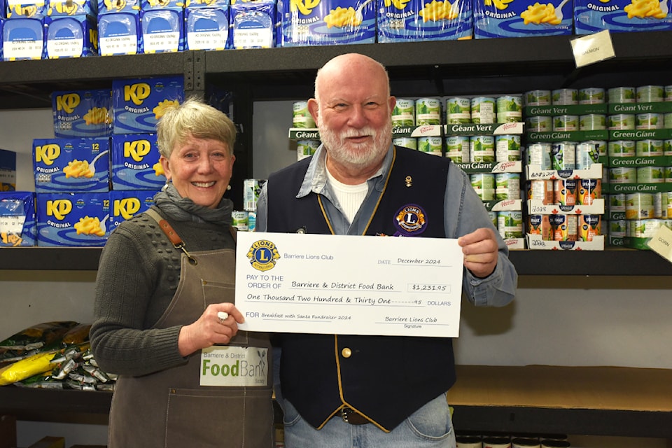 Jim Biller, of the Barriere Lions Club, right, presents a donation in the amount of $1,231.95 to the Barriere and District Food Bank accepted by president Louise Peters. 

