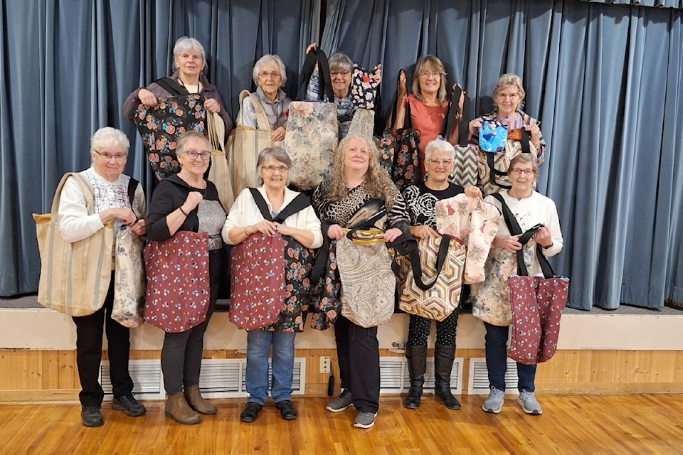 Barriere quilters hold up the bags they made for the Anti-Violence Society of Barriere to donate to Kamloops area shelters for women and children at Christmas time. 