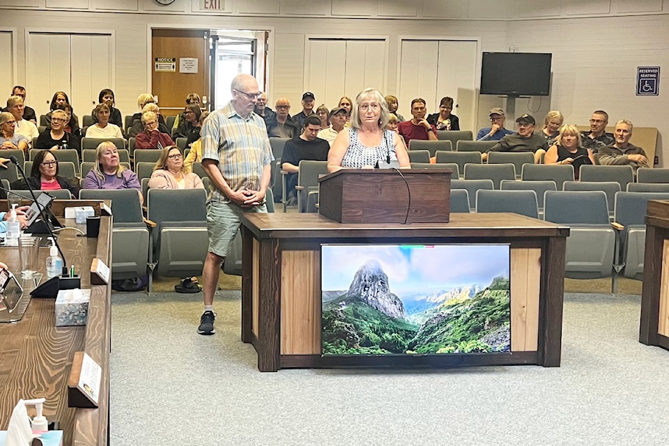 Pickleball club members in the gallery at city hall on July 8 hold up their paddles.
