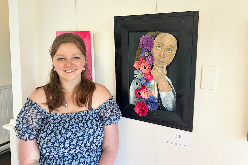 Rachael Folland with her piece Unmasked in the summer exhibit a the Station House upper gallery.