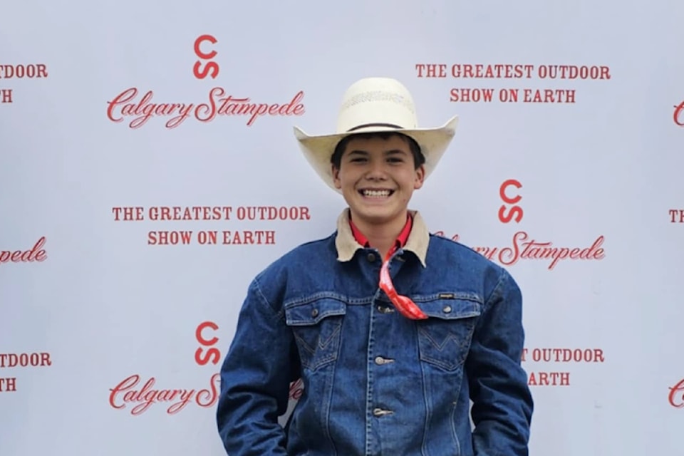 Junior steer rider Tanner Loring of Riske Creek shares a sweet smile after his second place win overall at the Calgary Stampede on July 12, 2025.