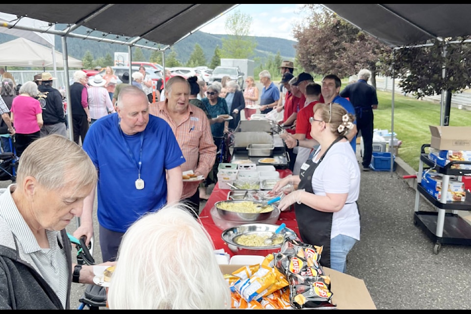 The Rotary Club of Williams Lake cooks hot dogs and hamburgers for the Seniors Village's Stampede Barbecue, and salad is prepared by the home's chef Greg and his team. 