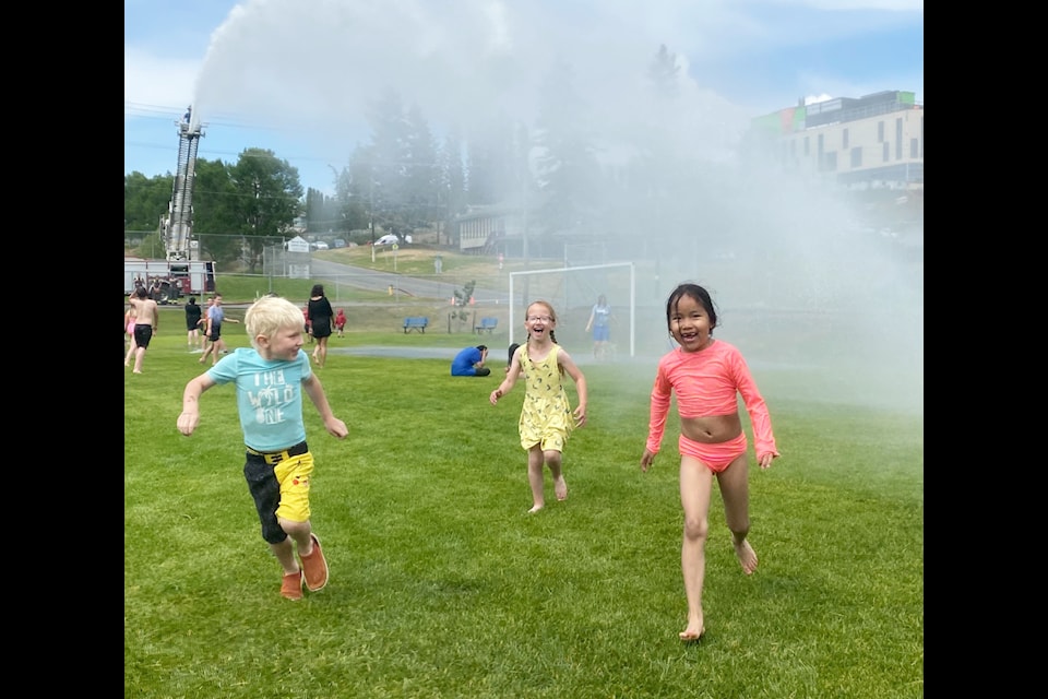 Ryan Neeson-Mitchell, Brooke Hilton and Veronica Elkins enjoy a hint of the summer fun that’s to come as the Williams Lake Fire Department creates a splash at Marie Sharpe Elementary. 