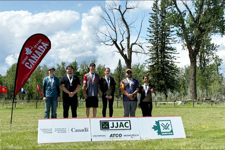 Lily Fraser, left, and Scott Allen, second from left, make the podium at an archery competition in Calgary.