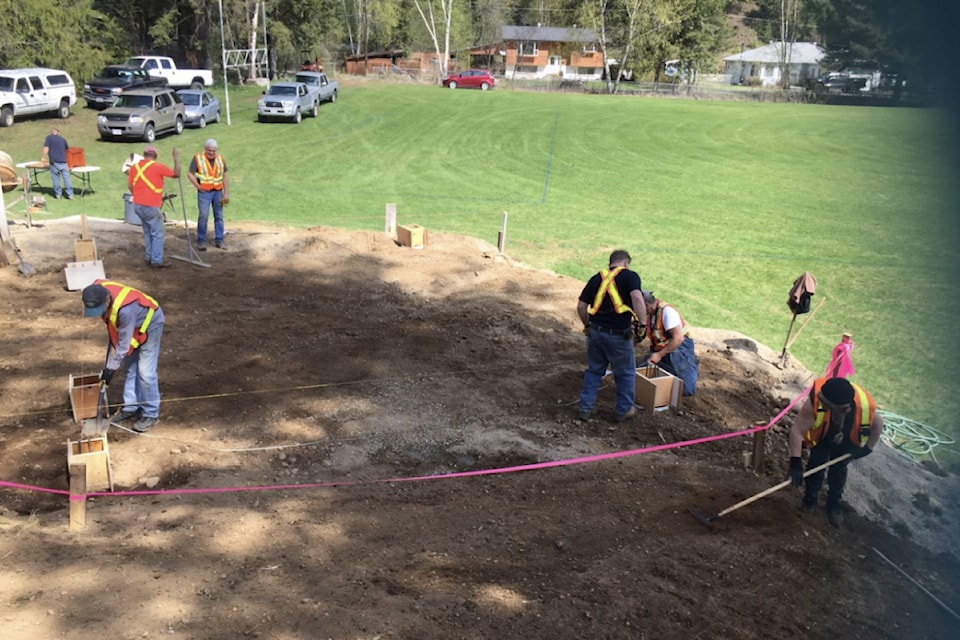 Doug Fenwick (blue cap), Howard Mitchell (facing in distance) and
Joe Vigneau work on the outdoor stage the Dutch Lake Community Centre in May 2018. 