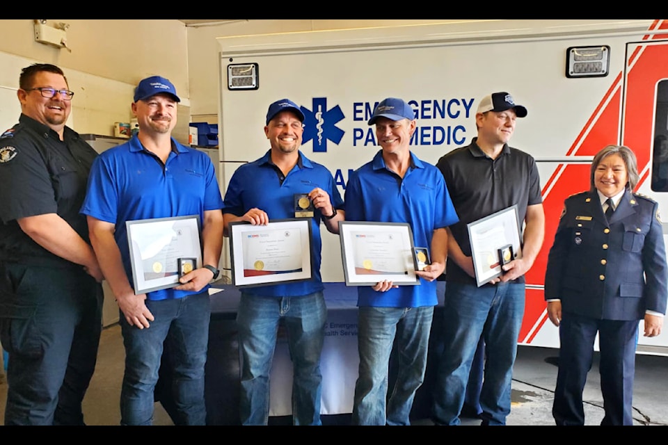 Williams Lake BCEHS primary care paramedic Daniel Bott, left, and regional manager Geraldine Elkins, right, present Good Samaritan awards to Gibraltar Mine workers Brian Getson, Shawn Shaw, Jonathan Neufeld and Richard Skerry. 