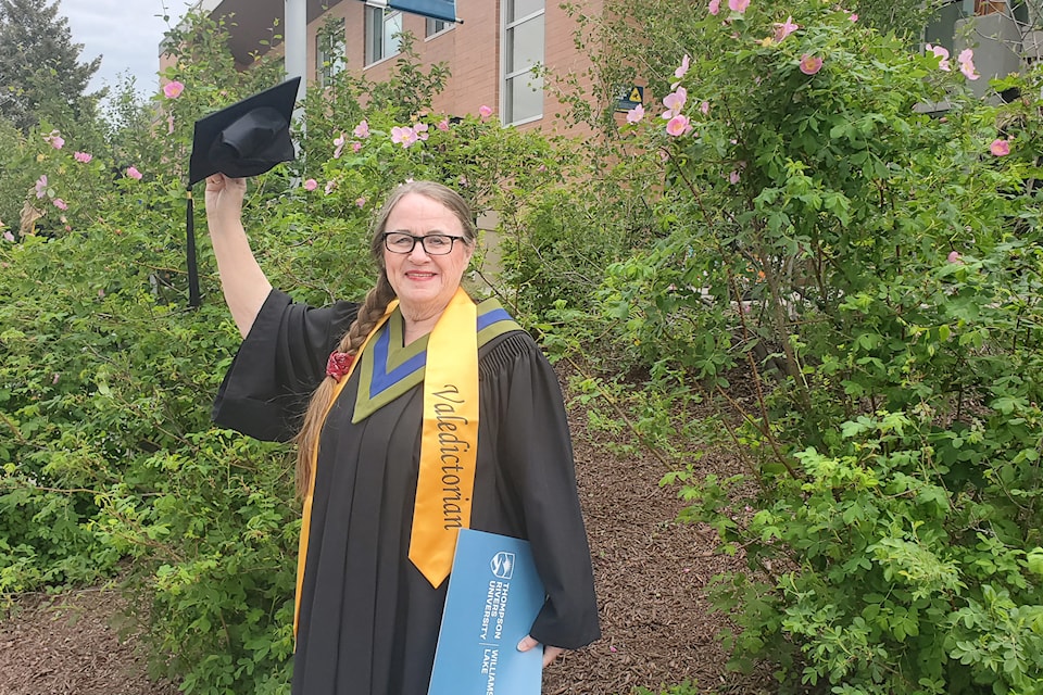 TRU Williams Lake valedictorian Jorunn Lindzén, 72, holds her cap up proudly after delivering an inspiring speech during the 2025 commencement in Williams Lake on Friday, May 30, 2025. 