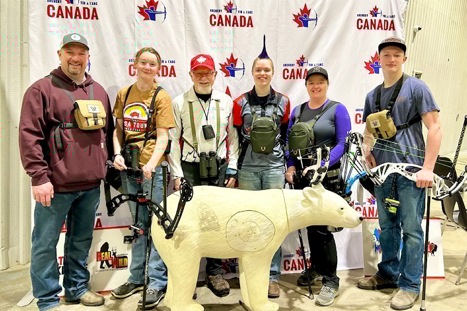 Six Cariboo Archers pose with a 3D target while at a competition in Manitoba.