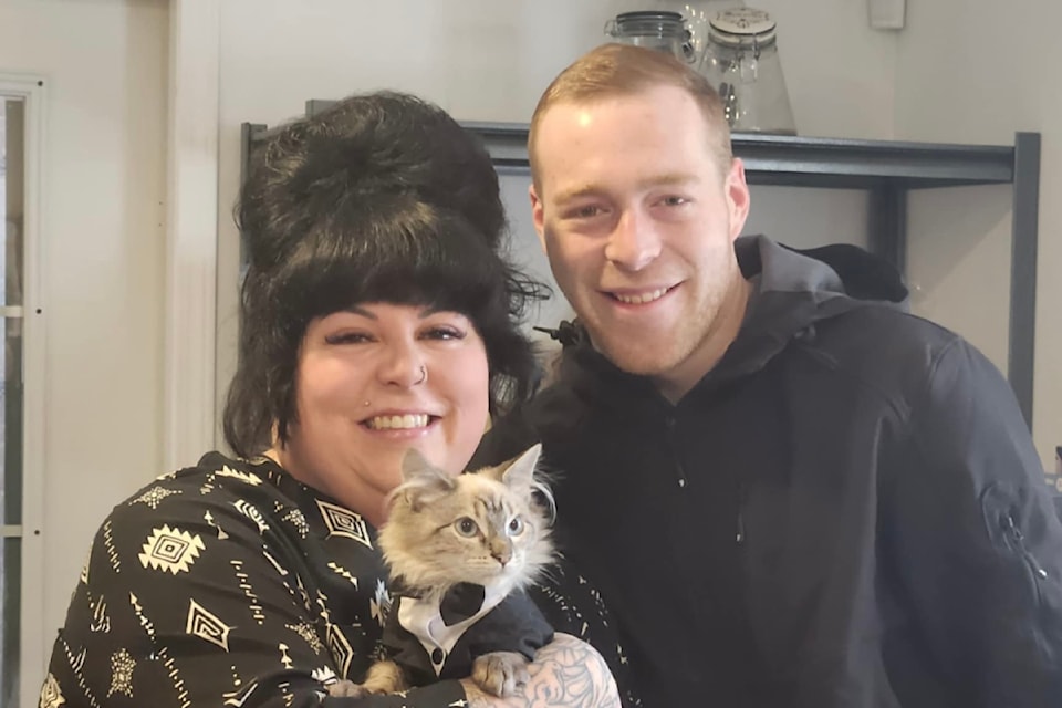 Brielle and Mackenzie Gagnon of Williams Lake hold their newest cat, Bourbon, wearing his adoption suit.