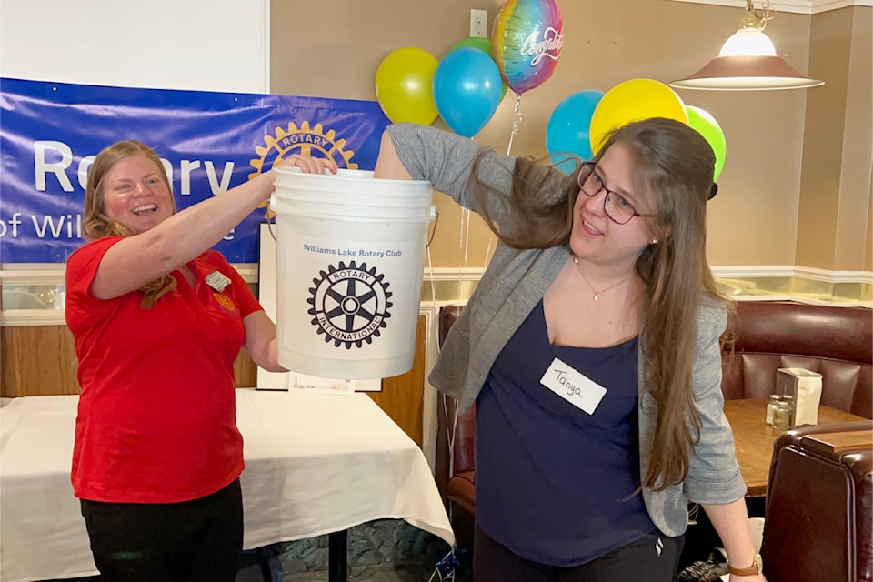 Amber Stratton, president of the Rotary Club of Williams Lake, and Tanya Vigeant, of All Ways Travel, draw the prize winners of the Rotary raffle on April 2.