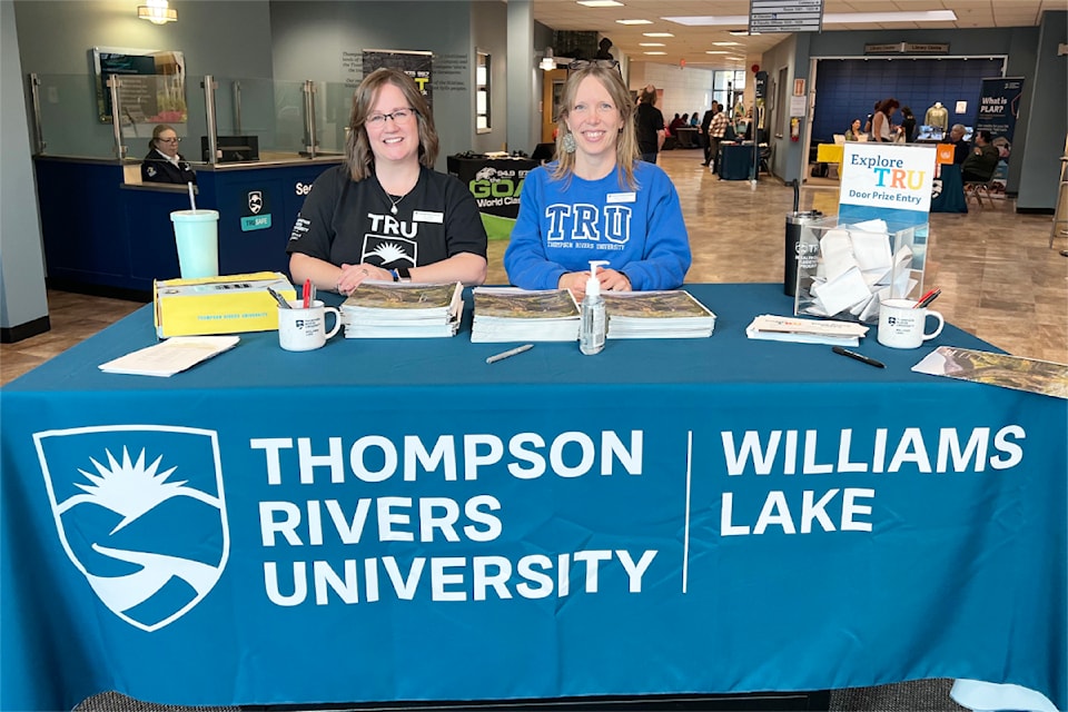 Amy Carson, left, and Rosalie McMartin greet attendees to get them set to Explore TRU.