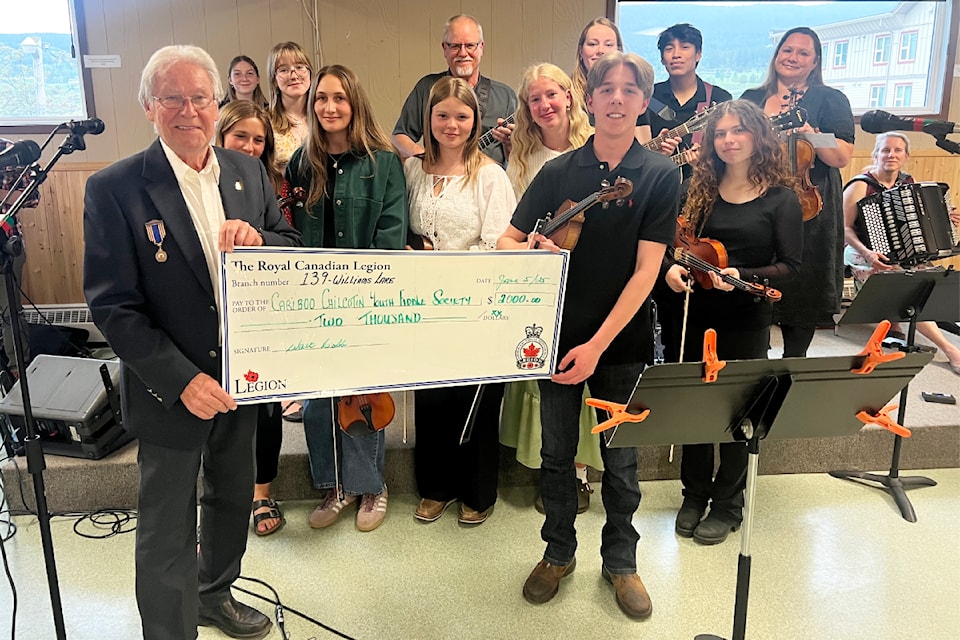 Walt Cobb, Legion 139 president, presents a cheque to the Cariboo Chilcotin Youth Fiddle Society to go towards the group's trip to Ireland in July.