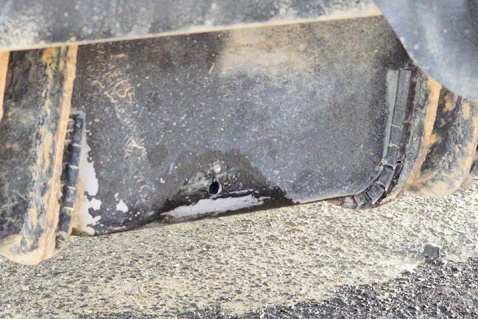 A hole drilled in a fuel tank resulted in damage to the vehicle and fuel in a business parking lot on May 7, 2025.