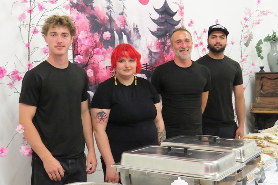 The crew from the Gateway Grill 
ready to serve food during the Garden Tea held Sunday, May 4 in Clearwater. 