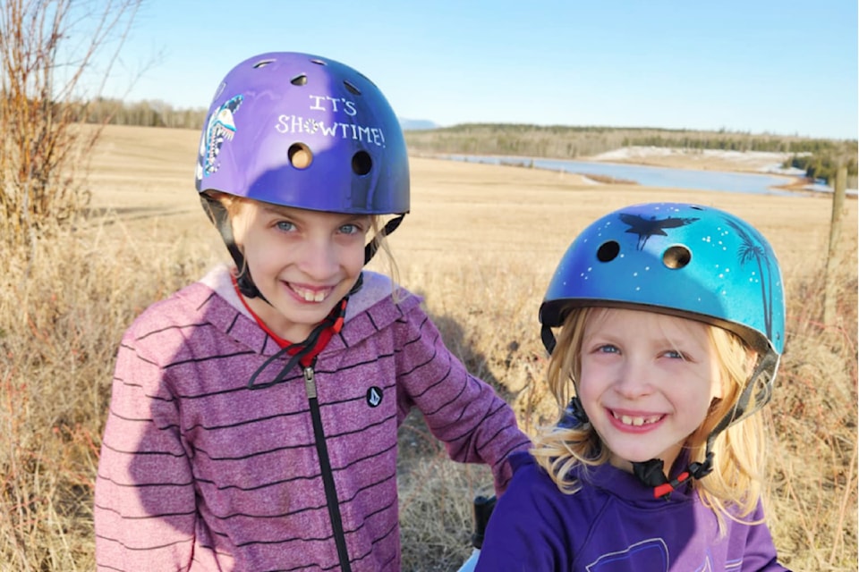 Astrid and Kyren of the Williams Lake area are enjoying personalized helmets painted by their mom, Mandee Bartley. 
