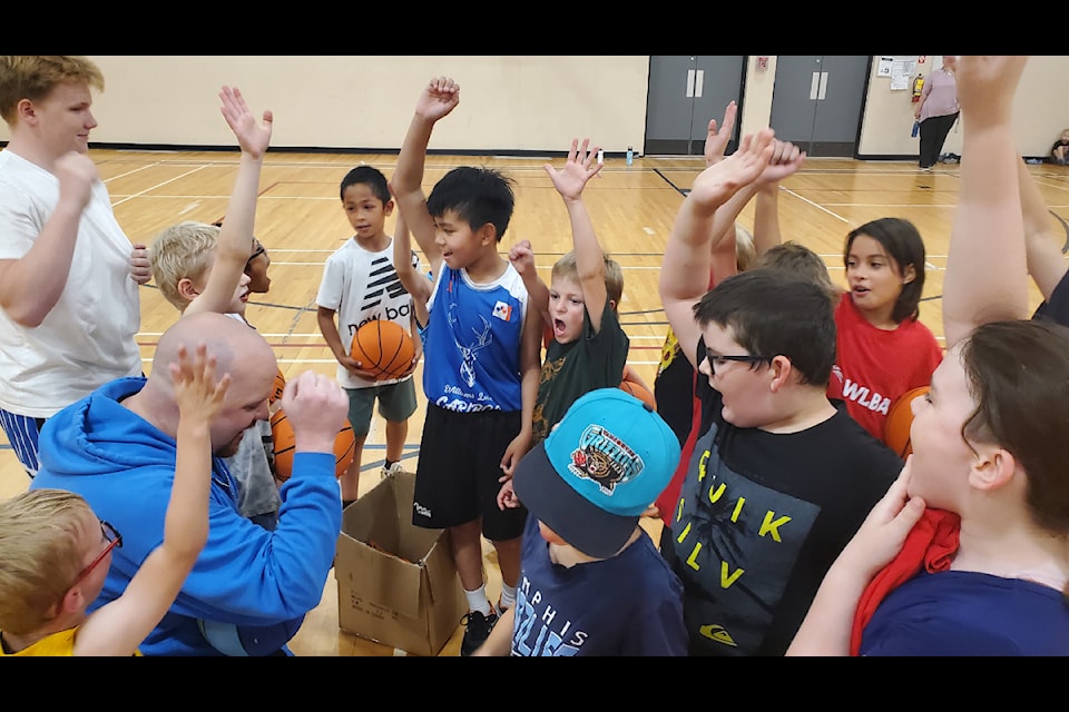 Participants give three cheers for basketball at the end of a two-day camp in Williams Lake. 