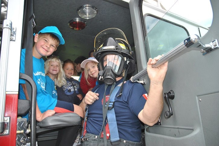 63228tribuneDSC_1866-firefighter-in-mask-with-kids