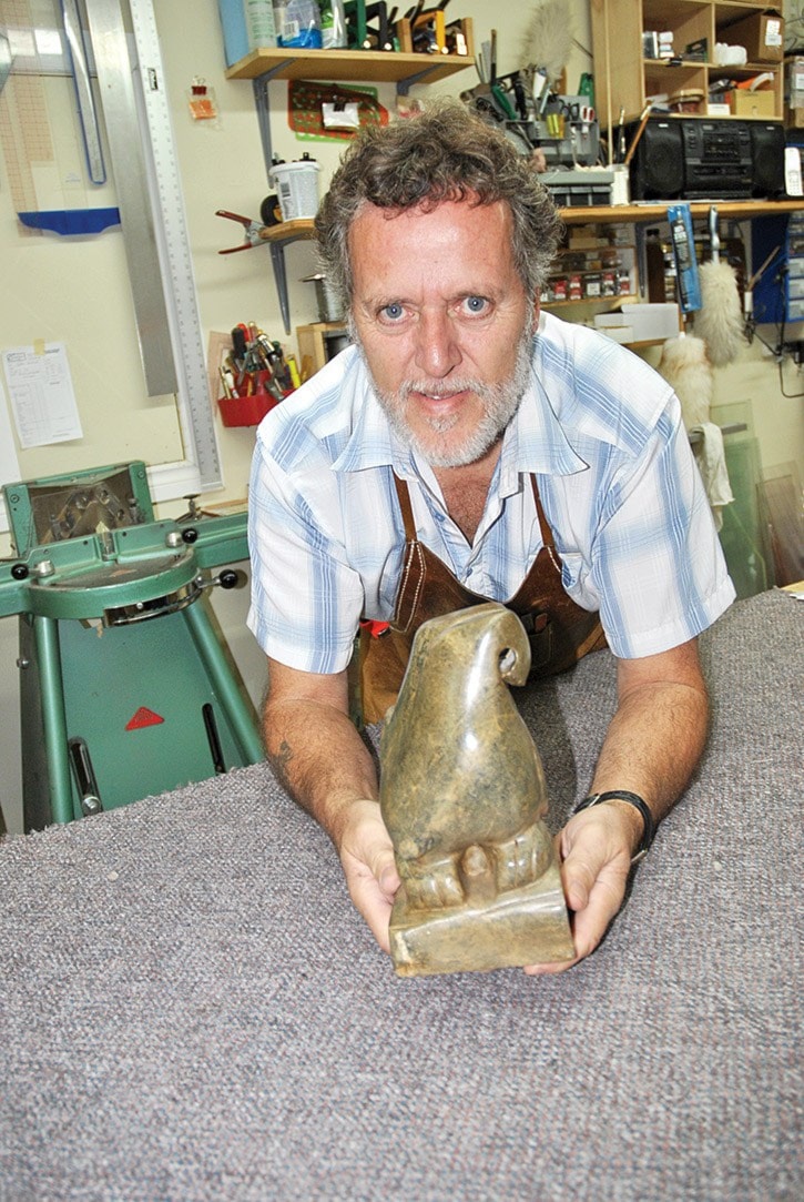 90739tribuneDSC_1671-Bruce-Charbonneau-with-a-piece-of-his-sculpture.-His-work-is-at-The-Realm-of-Toys