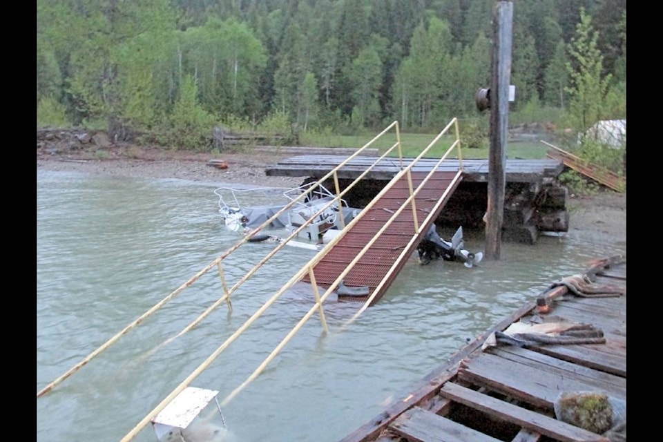 Sam Fait photo A sunken boat and the remnants of a community wharf called the corrals by locals are all that remain at the site where a powerful storm pounded an area on the North Arm of Quesnel Lake Tuesday evening.