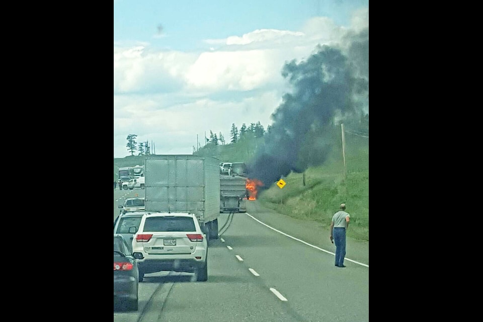 Stu Milne photo Traffic on Highway 97 was blocked off for about a half hour Wednesday afternoon as emergency crews battled a fire which broke out on a tractor trailer unit carrying nine vehicles, four of which the driver saved.