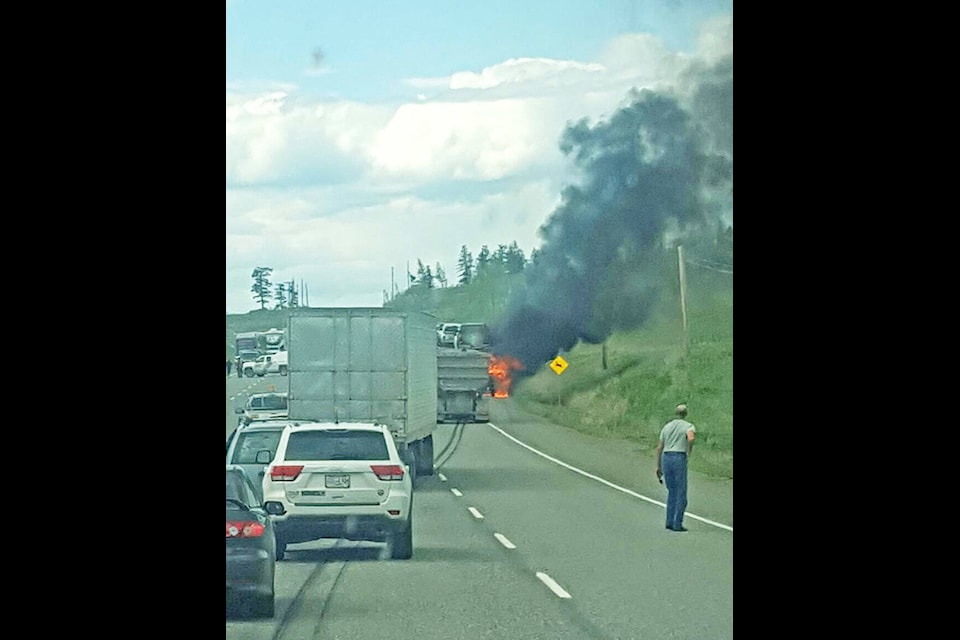 Stu Milne photo Traffic on Highway 97 was blocked off for about a half hour Wednesday afternoon as emergency crews battled a fire which broke out on a tractor trailer unit carrying nine vehicles, four of which the driver saved.