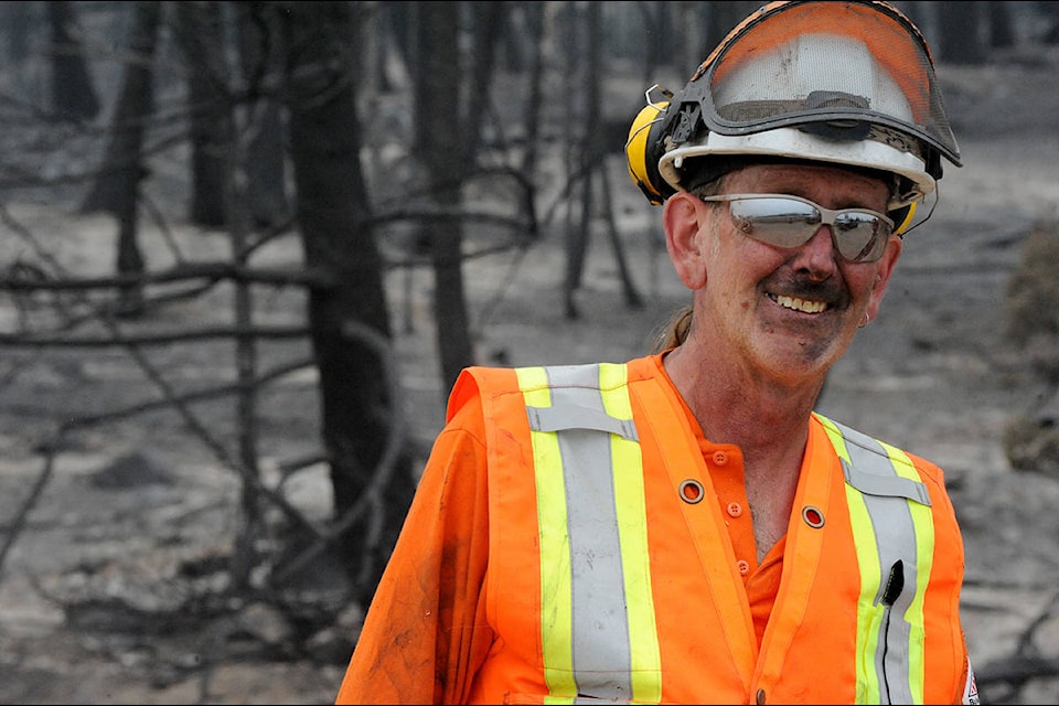 Simon Rollinson, a certified utility arborist, had the tough job of clearing danger trees from power lines along Highway 97 Monday. (Angie Mindus photo)