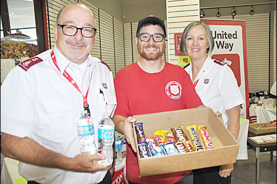 Brian Venables the Salvation Army’s B.C. divisional commander (left) with new SA cadet Joel Torrens and his wife Anne Venables who are in Williams Lake with a large contingent of Salvation Army members helping to provide support for people impacted by the wild fires raging around Williams Lake and the Chilcotin. Torrens has been giving out chocolate bars to people registering their return to Williams Lake at the Resiliency Centre located in the upper level of Boitanio Mall. Gaeil Farrar photo