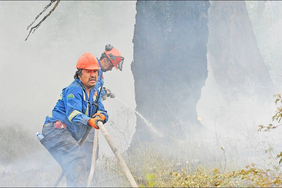 Angie Mindus photo Alexis Harry Sr. (front left) and Darrick Andrew control a blaze in the Hanceville-Riske Creek fire recently. The two fire fighters are part of the eight, six-man crews that make up the Alkali Resources Management, or ARM, of the Esk’etemc First Nation who have been fighting wildfires in the Cariboo Chilcotin all month. For more on ARM please visit our website at www.wltribune.com. Alexis Harry Sr. and Darrick Andrew control a blaze in the Hanceville-Riske Creek fire recently. The two fire fighters are part of the eight, five-man crews that make up the Alkali Resources Management, or ARM, of the Esk’etemc First Nation who have been fighting wildfires in the area all month. (Angie Mindus photo)