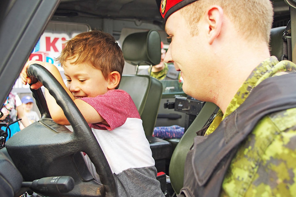 Kisho Baba, 5, enjoys steering an army vehicle thanks to a recent visit by the Canadian Armed Forces to Kidscare Daycare in Williams Lake. Captain Graham Kallos photo.
