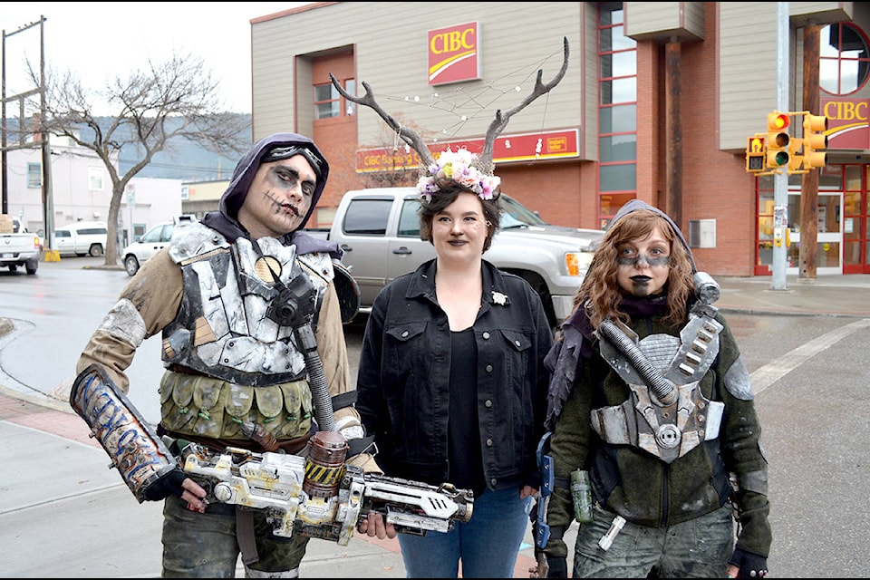 Bronson Rames (left) and Chantal French (right) dressed as some type of “apocalypse people” while Anya Paloposki joked that she was their catch of the day.