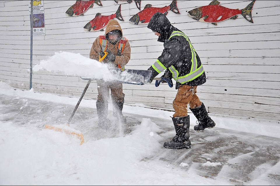 RONA employees Chris Harrop (left) and Brody Penney were hard at work Sunday morning clearing the business’s sidewalks as snow continues to hammer down in the lakecity. (Greg Sabatino photo)