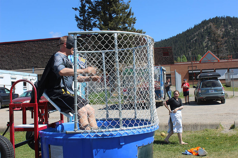 Braden McCullum - dressed as batman - is successfully dunked by a student as one of the activities at Canada Day in May at the secondary school.