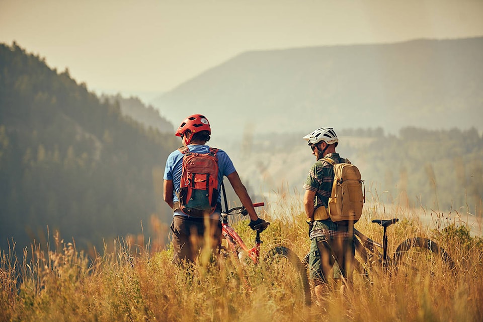 Tom Eustache (left) of Barriere and Dan Schaefer, a journalist from Germany, look down upon the Fraser River at Soda Creek.