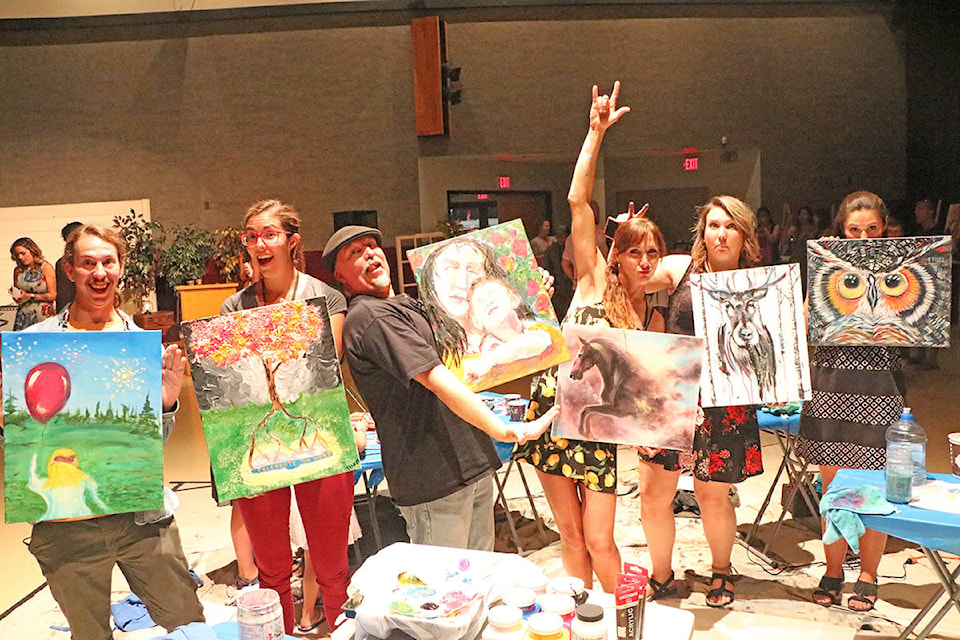 Steven Davis-Gosling (from left), Tiffany Klassen, Dwayne Davis, Tiffany Jorgensen, Sarah Sigurdson and Amy Piquette show off their masterful works of art after having just 45 minutes to paint during the grand opening party for Downtown Williams Lake Art Walk Wednesday night at the Gibraltar Room. Patrick Davies photo