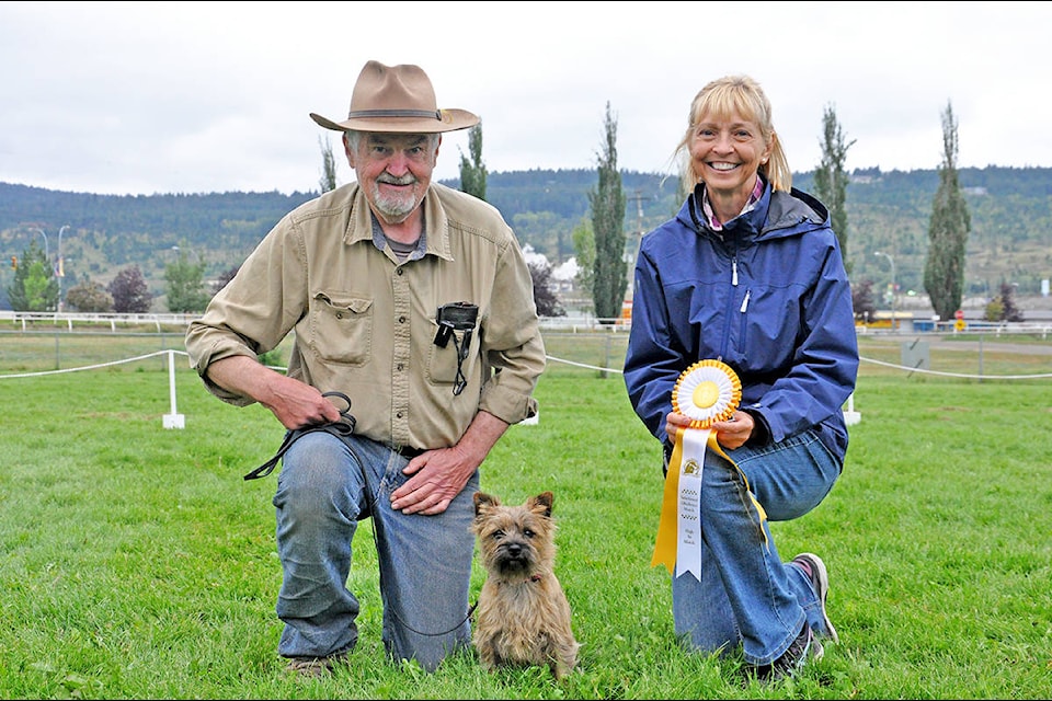 Dog obedience judge Leslie Earnst presents Peter Reid of 100 Mile and his dog, Hazel - a Cairn Terrier - the high end trial award in the novice class at the Williams Lake Harvest Fair Sunday. (Greg Sabatino photos)