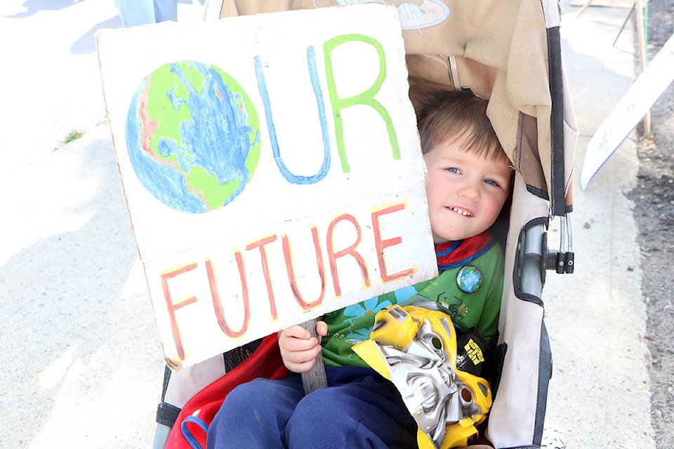 River Watts holds up a handmade sign at the Global Climate Strike and March on Friday, Sept. 20. Patrick Davies Photo.