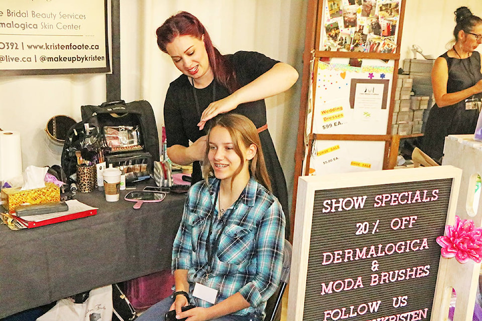 Kristen Foote the organizer of the Cariboo Wedding and Grad Show styles Bree Grondines’ hair during the show. Patrick Davies photo.