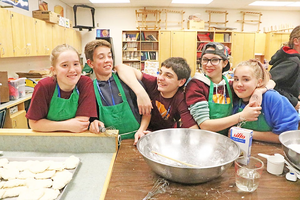 Lakecity students Claire Munroe (from left) Joseph Henley, Brayden St. Onge, Lenaya Schuk and Crystal Jessee horse around while they prepare to assist in making bannock for attendees of the B.C. Student Leadership Conference. Patrick Davies photo.