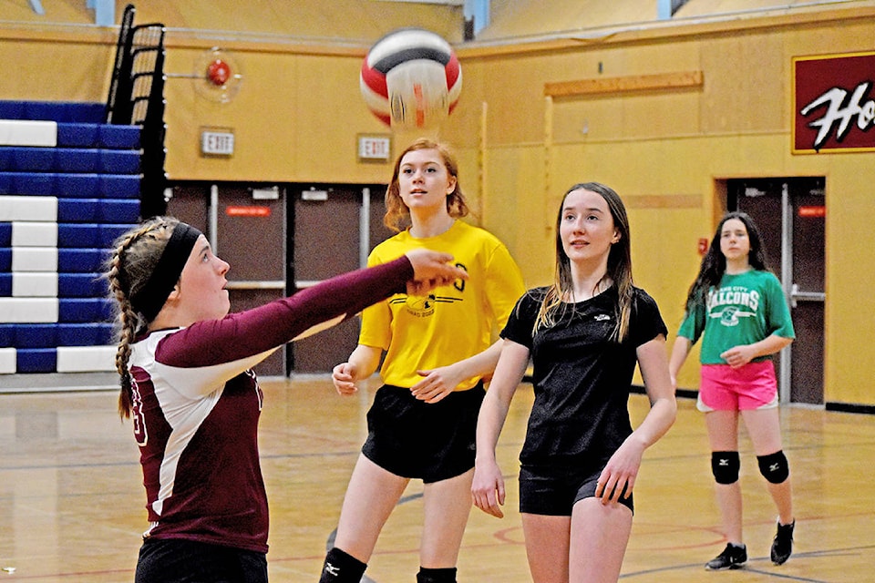 Greg Sabatino photo Lake City Falcons volleyball player Joelle Thurow (from left) lays up a bump while teammates Katie Benastick and Sienna McCarvill support.