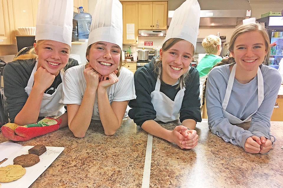 Kate Neufeld (from left), Olivia Dickens, Carmen Dyck and Maeghan McDonough were some of the chefs volunteering at the Menno Cafe at the 10,000 Villages Market on Friday. Jasmine Alexander photo.