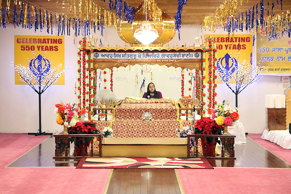 Harminder Kaur Saini reads continuously from the Adi Granth, Punjabi for the ‘First Book’, the sacred scripture of Sikhism to celebrate the 50th birthday of Lord Nanak, the founder of the Sikh Religion. Patrick Davies photo.