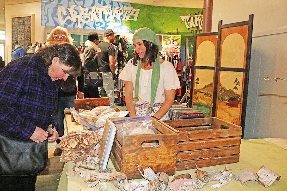 Shannon Zirnhelt of the Birch Bark Bakery chats with a customer at the Medieval Market on Saturday, Nov. 23. Patrick Davies photo.