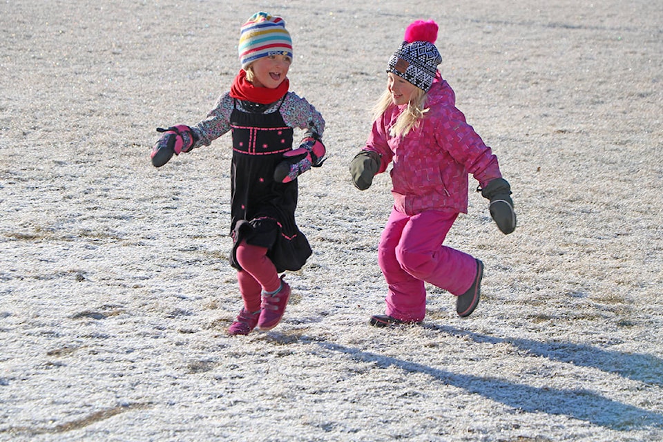 Keelan Mccoubrey laughs as her friend Emilia Hannas chases her around LCCS Lake City Campuses’ frosty field as they prepare for the Innaugural Frosty 5-KM Walk/Run on Saturday, Nov. 30. Patrick Davies photo.