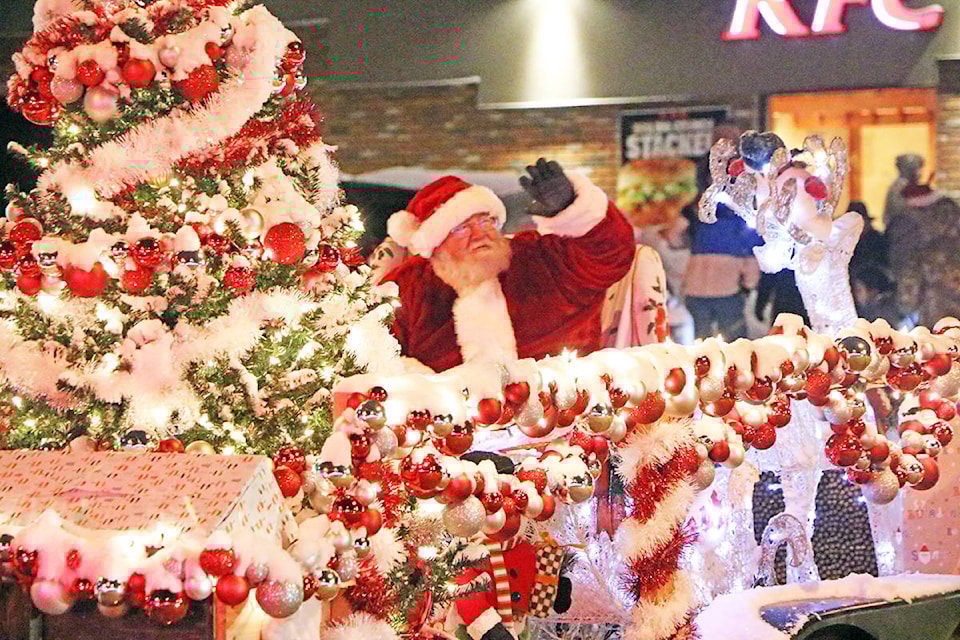 Santa Claus waves cheerfully from the back of a float in the annual Winter Lights Parade. (Patrick Davies-Efteen)