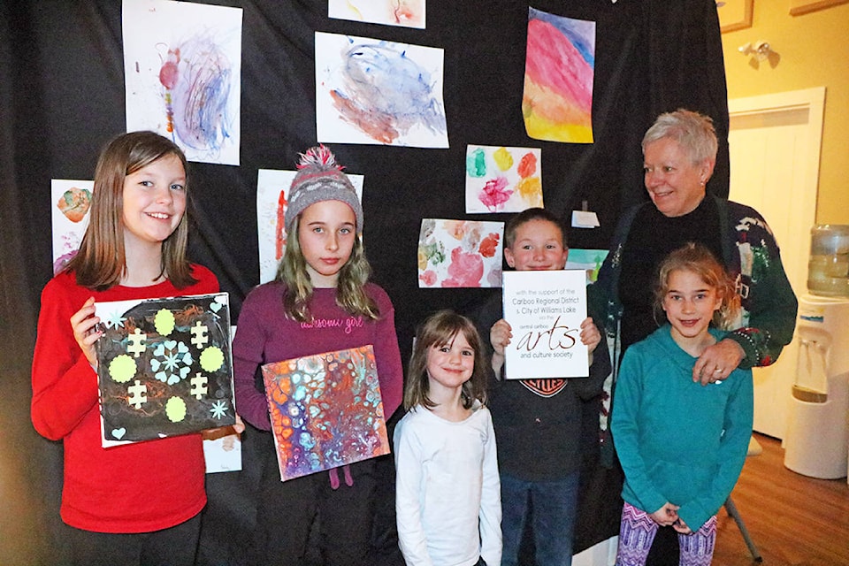 The Uptown Art Program’s art show was a cosily attended event by artists and their families including Sydney Hamm (from left), Chenelle Tomlin, Emily Hamm, Nathan Hamm, Raquel Tomlin and Lesley Lloyd, seen here showing off some of their artwork. Missing from the photo was Savanna Mateus-Bujold, Morgan Russell, Kiera Primeau and two others who preferred to remain nameless. (Patrick Davies-Williams Lake Tribune photo)