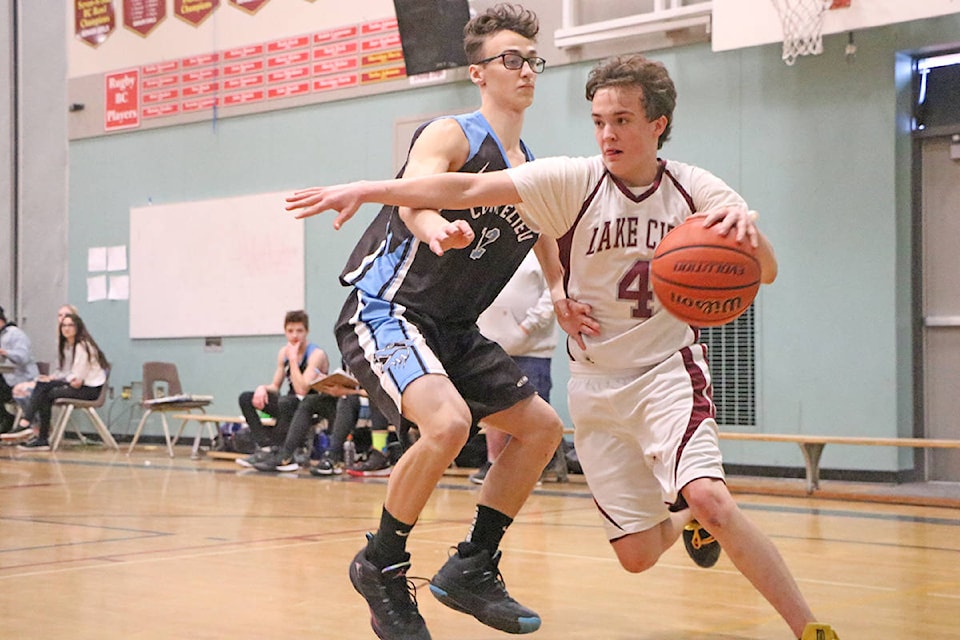 Falcons player Ethan Michel drives past a Correlieu player in the team’s opener at its home tournament Dec. 13. (Patrick Davies photo - Williams Lake Tribune).
