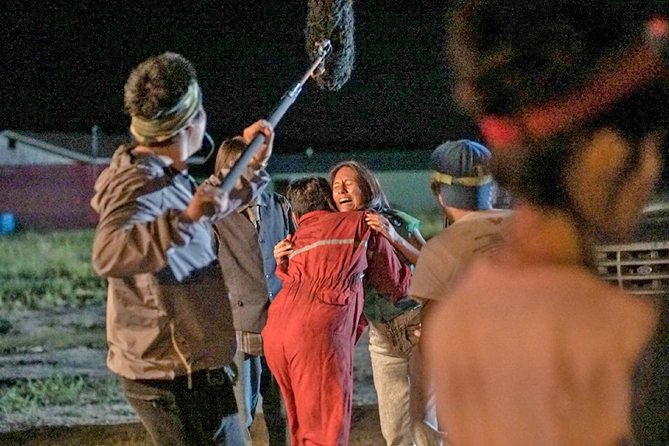 Pauline Bob-King (centre) laughs as she emerges from a pond on one of the final days of shooting Portraits From a Fire. Photo submitted)