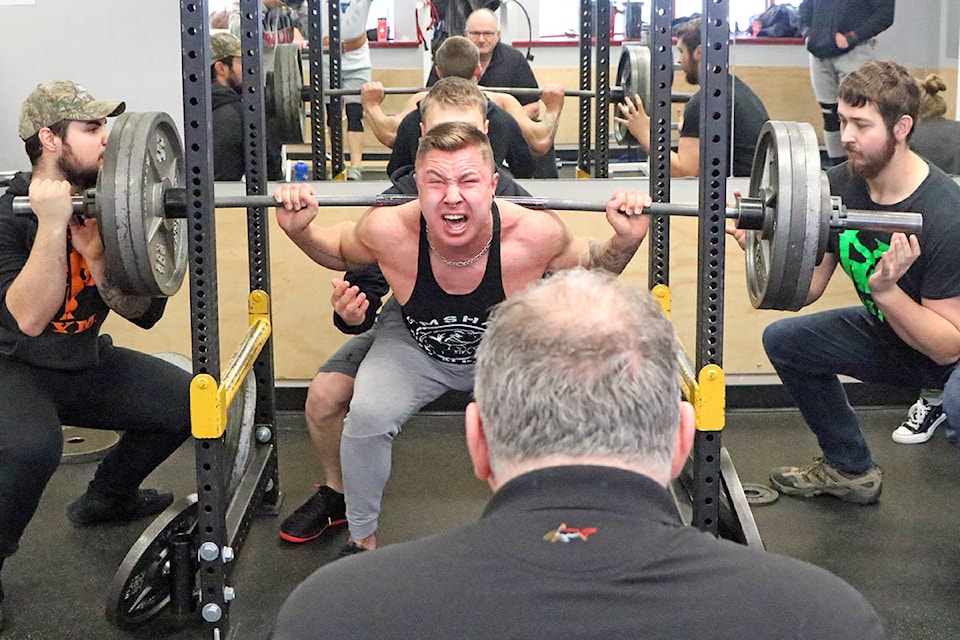 Landen Stasica lets out a yell as he squat presses during Cariboo Classic Amateur Powerlifting Competition held at Concrete Fitness. (Patrick Davies photo-Williams Lake Tribune)